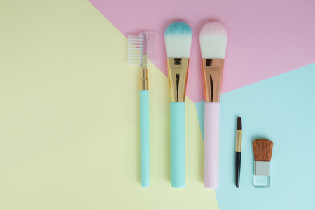 Flat lay creative concept of female decorative cosmetic many types cheeks brush on the colorful background with copy spaceの写真素材