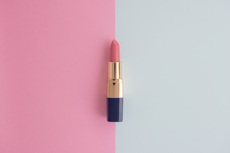 Flat lay of creative female cosmetic for pink lipstick on the colorful background with copy spaceの写真素材
