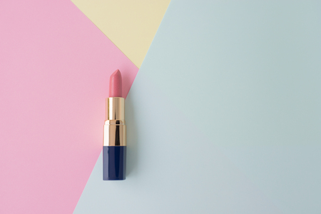 Flat lay of creative female cosmetic for pink lipstick on the colorful background with copy spaceの写真素材