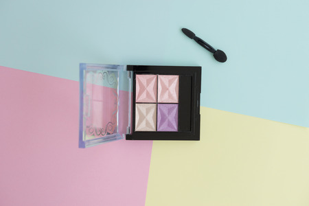 Flat lay of creative female decorative cosmetic for eyeshadow palette on the colorful background with copy spaceの写真素材