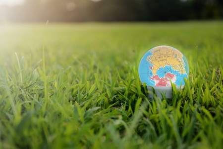 LED Bulb as a earth on the grass for eco conceptの写真素材