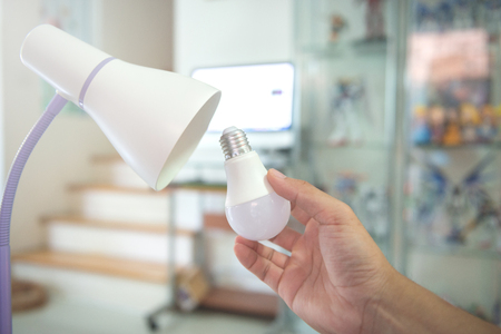 Changing the bulb to LED to install in the lamp for energy savingの写真素材