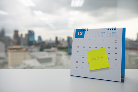 Close up of vacation on paper note stick on the calendar of December for year end holidays conceptの写真素材