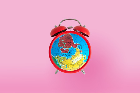 Bell clock with global on the front for timing conceptの写真素材