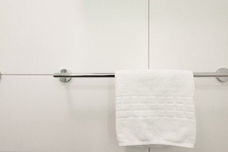 White towel hanging on the clothes rack in the bathroom in the hotelの写真素材