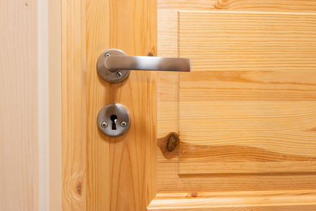 Close up of wooden hotel door and door handlesの写真素材