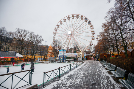 Oslo / Norway - December 01 2018 : People are playing the ice skate with ferris wheel as a background in winterのeditorial素材