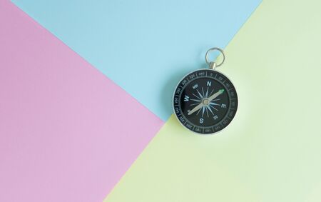 Compass on the colourful background for travel concept