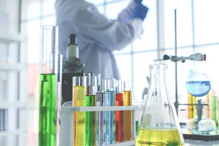 Close up of glass laboratory chemical with chemical compounds inside in the lap and test by medical research scientistの写真素材