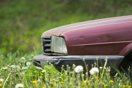 Photographed part of the old abandoned car on a meadow.の写真素材