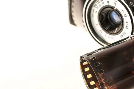 Photographed old photographic film and camera on a white background.の写真素材