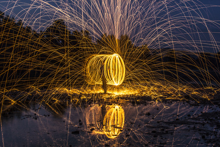 Light painting on the river. Long exposure and steel wool.の写真素材
