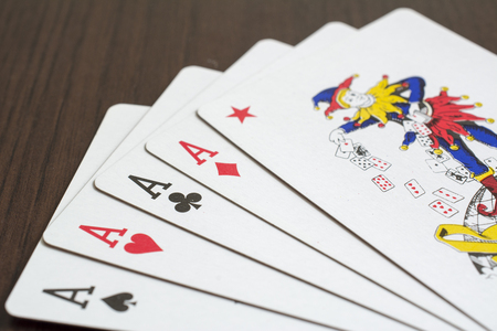 Poker cards on brown table.の写真素材