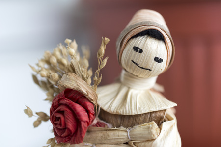 Hand made doll with flower from the dried leaves and parts of cereals.の写真素材