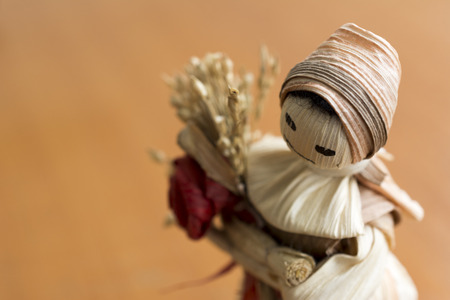 Hand made doll with flower from the dried leaves and parts of cereals.の写真素材
