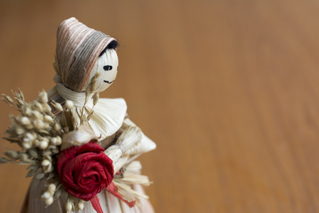 Hand made doll with flower from the dried leaves and parts of cereals.の写真素材