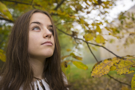 Girl in a morning walk through a misty forest.の写真素材
