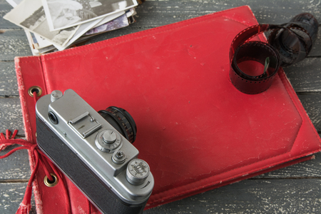 Old film and camera on a wooden background.の写真素材