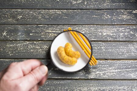 Snacks in a small plate magnified by a magnifying glass.の写真素材
