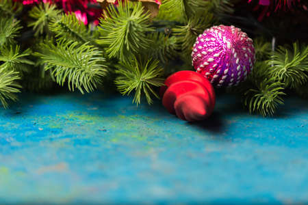 Holiday decorations and evergreen branches left on the table.の写真素材