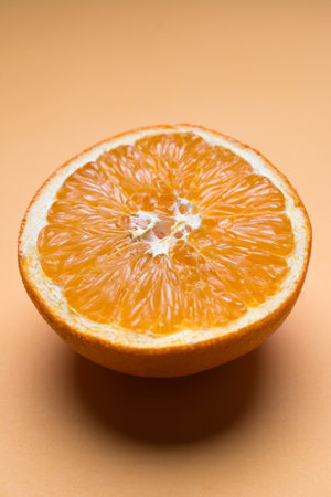 Sliced orange placed on an orange background.の写真素材