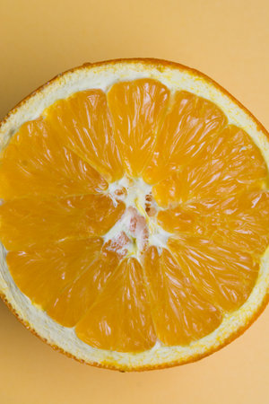 Sliced orange placed on an orange background.の写真素材