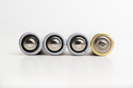 Spent batteries stacked in a row isolated on a white background.