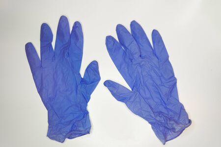 blue silicone women's pair of gloves size M, on white backgroundの写真素材