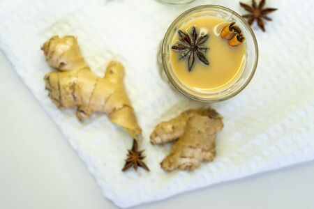 selective focus, Indian masala tea on a white background on a starched napkin, with spices of...