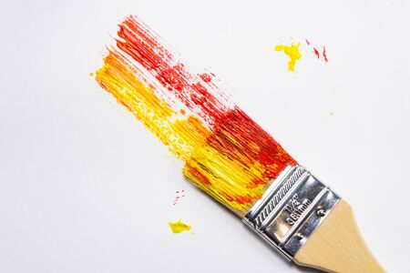 large paint brush with oil color paint, painted bright background with brush marksの写真素材