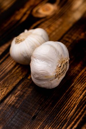 selective focus, fresh garlic head on dark charred wood backgroundの写真素材