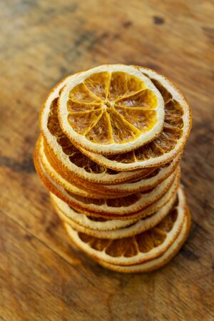 home preparation. sliced dried orange, slices, natural fruit chips without sugar and spicesの写真素材