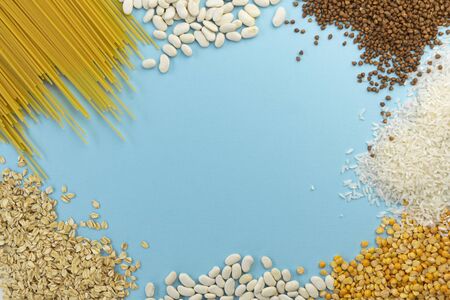 selective focus, food help on the table, cereals and pasta. top view, copyspace