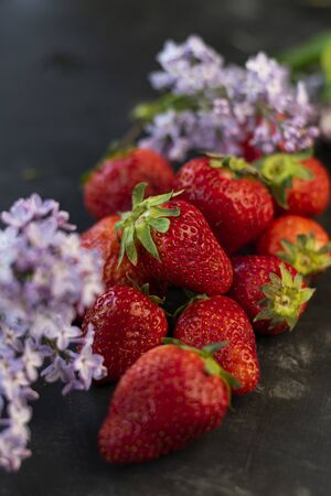 selective focus: large ripe strawberries on a dark background, neatly foldedの写真素材
