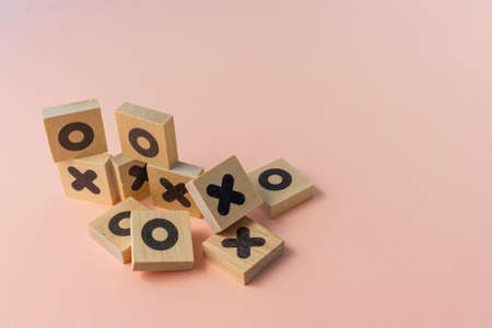 selective focus, wooden dice game TIC-TAC-toe on a paper colored background, copyspaceの写真素材