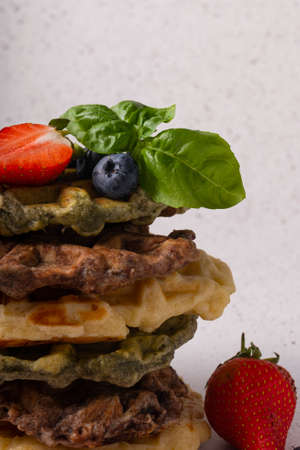 selective focus, curd waffles with vanilla and fresh berries on a light backgroundの写真素材
