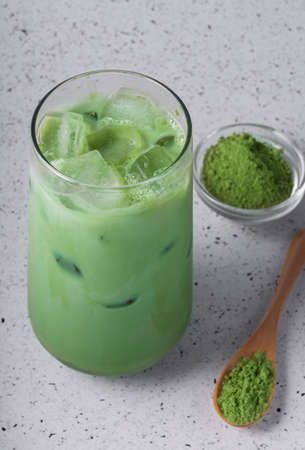 selective focus, natural drink matcha with ice, latte with milk. tea in a tall glass