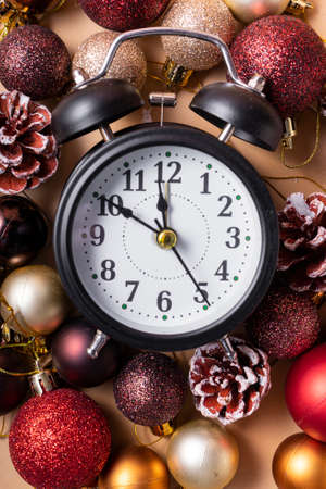 selective focus. new year's clock with hands at ten to twelve. with Christmas plastic balls and...