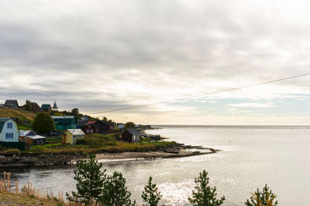 wooden old house on the river, far outside the city, Murmansk region in autumn, copyspace, landscapeの写真素材