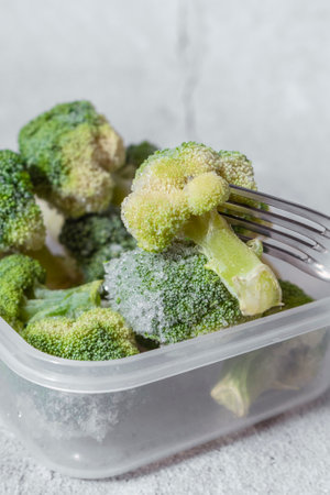 selective focus. frozen broccoli in a clear containerの写真素材