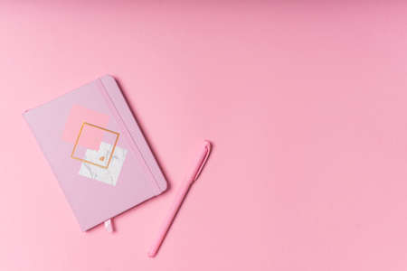 selective focus. Valentine's day layout. pink notepad with copyspace. on a pink paper background with stationery. the view from the topの写真素材