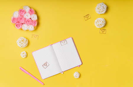 selective focus. Valentine's day layout. pink notepad with copyspace. on a yellow paper background with stationery. the view from the topの写真素材