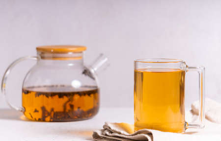 selective focus: Ceylon black tea in a transparent mug on a light background. copyspace. horizontal position. minimalistic styleの写真素材