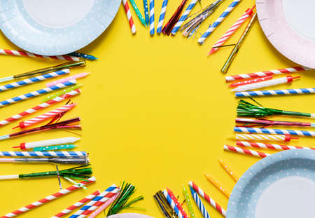 yellow birthday flatlay. colored paper tubes with wax candles. holiday concept, greeting card. copyspaceの写真素材