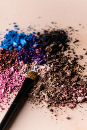 broken eye shadow scattered across the smooth pink surface. Texture background, advertising the structure of cosmetics. macro, copyspaceの写真素材
