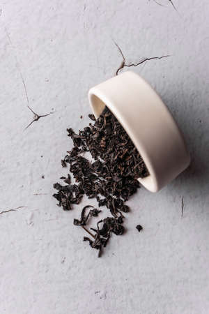 selective focus, natural black leaf tea in a clay bowl