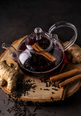 selective focus, freshly brewed tea in a transparent teapot, with fruits and fresh berries. leaf tea and spices. still-life. for advertising and menusの写真素材