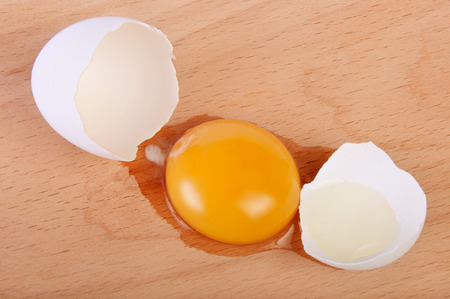 Broken raw egg on the chopping board