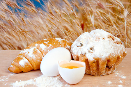 Eggs and fresh pastries on a cutting board