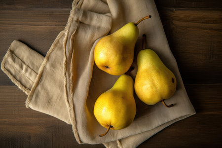 Ripe yellow pears on a wooden background. Top view.の素材